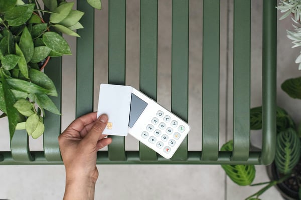 Credit card and POS machine. Photo by Mockuuups on Unsplash