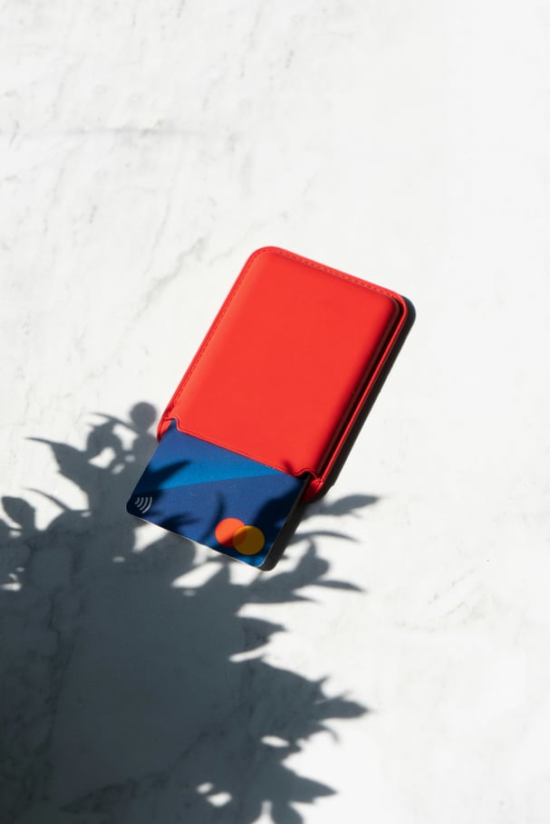 Red wallet with credit cards. Photo by Ron McClenny on Unsplash